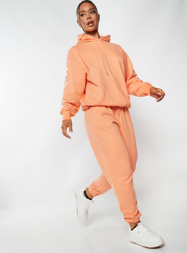 A model wearing peach hoodie and jogging bottoms from Boux Avenue
