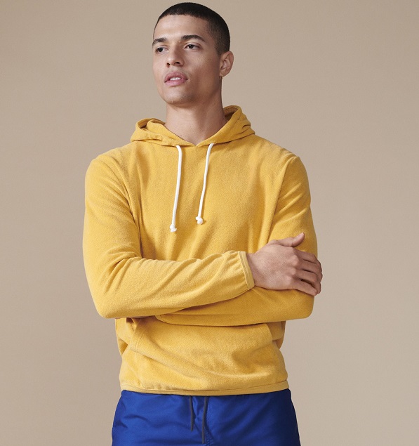 A model wearing a yellow hoodie